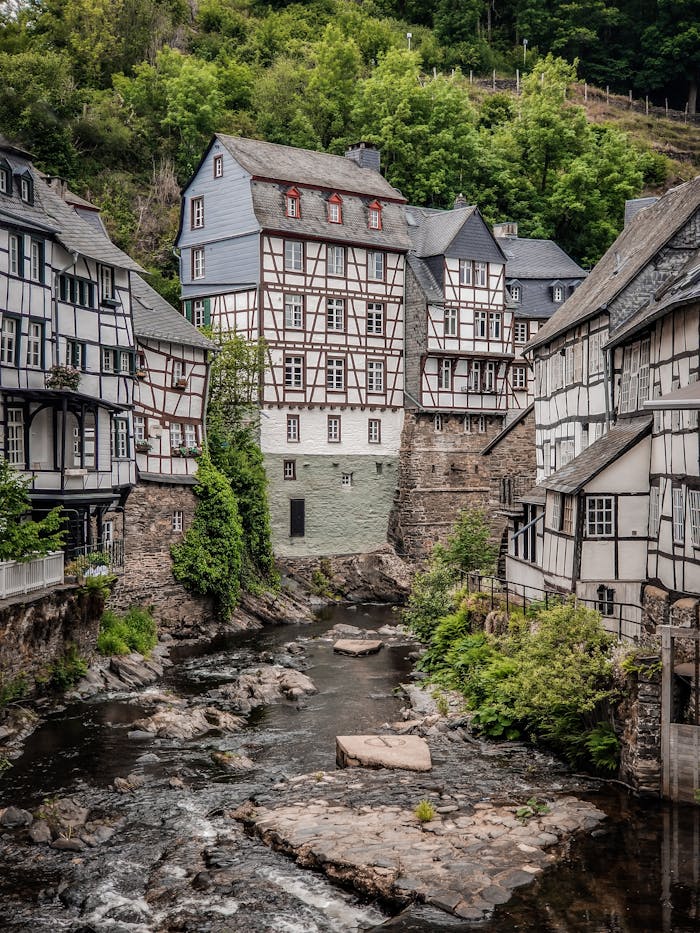 Charming historical architecture and flowing river in Monschau, NRW, Germany.