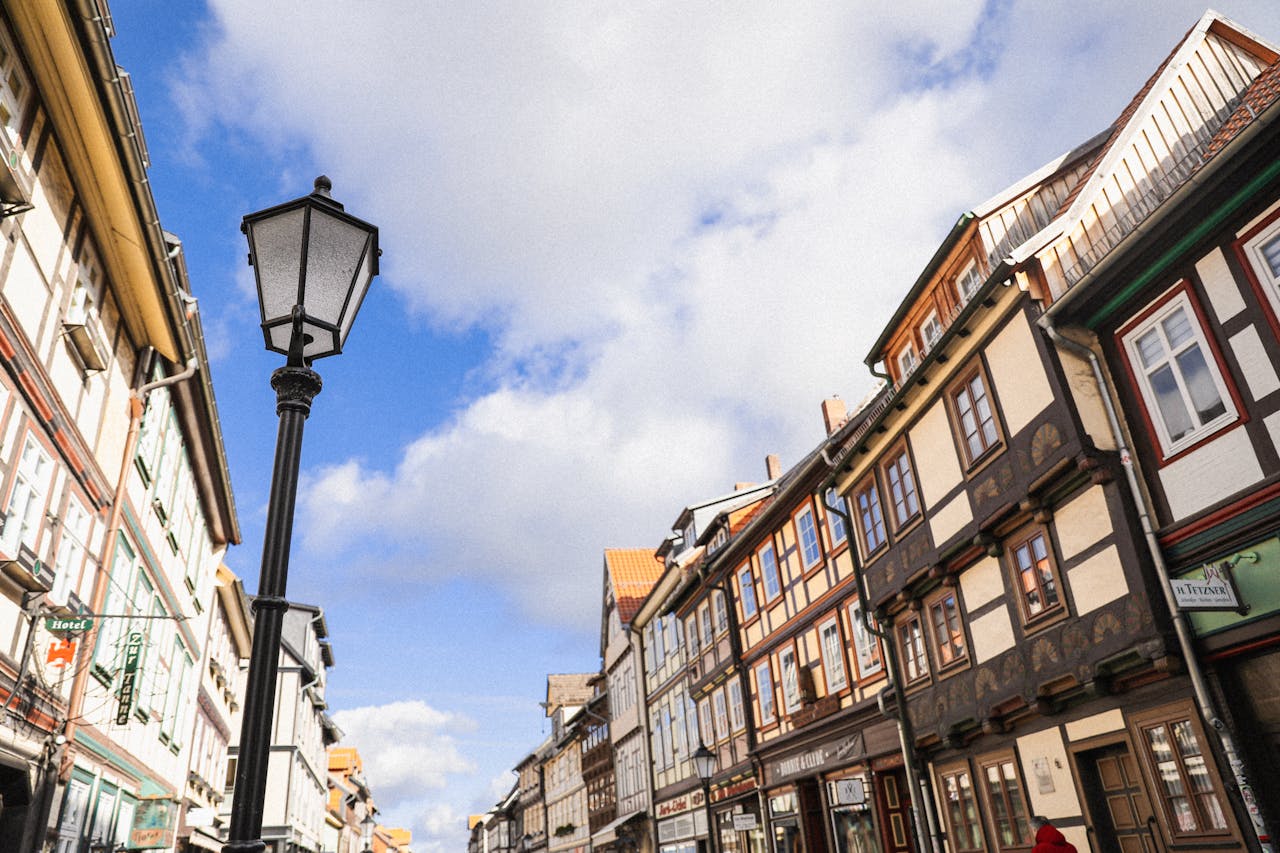 Beautiful street in Wernigerode with historic half-timbered buildings and a classic street lamp under a clear blue sky.